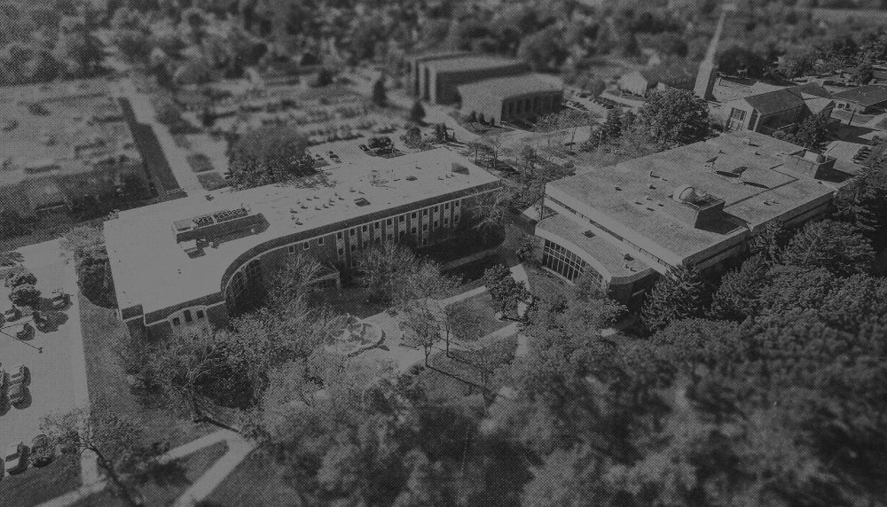 Aerial view of a campus with buildings and trees