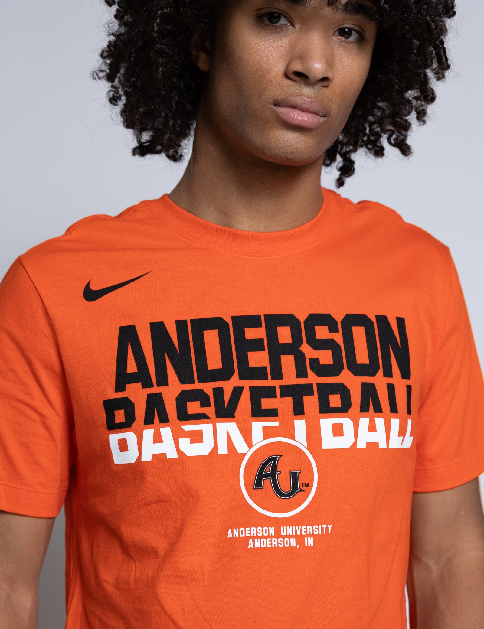 Person wearing an orange 'Anderson Basketball' t-shirt with Nike logo.