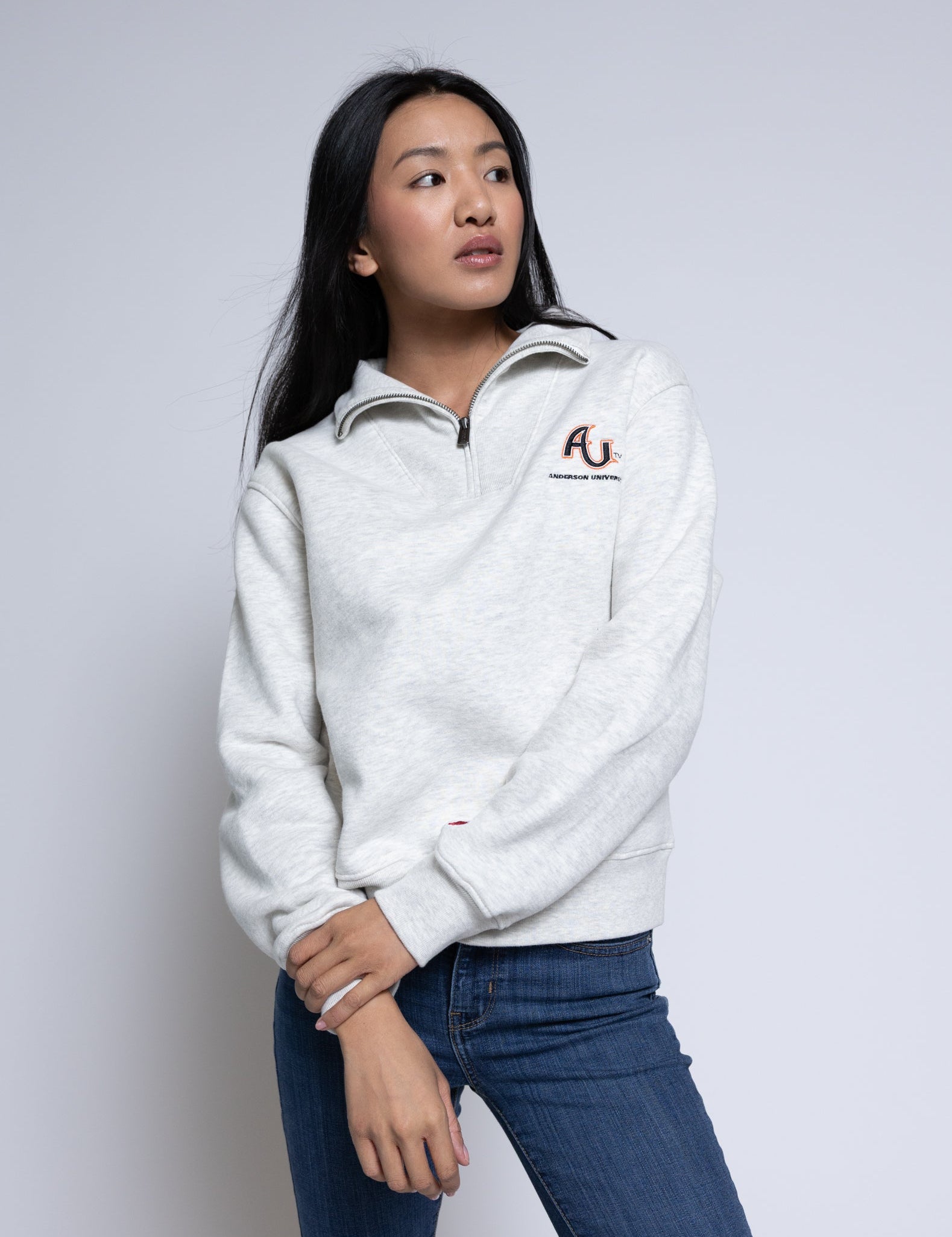 Person wearing a pullover with an AU logo standing in front of a plain background