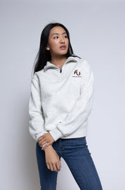 Person wearing a pullover with an AU logo standing in front of a plain background