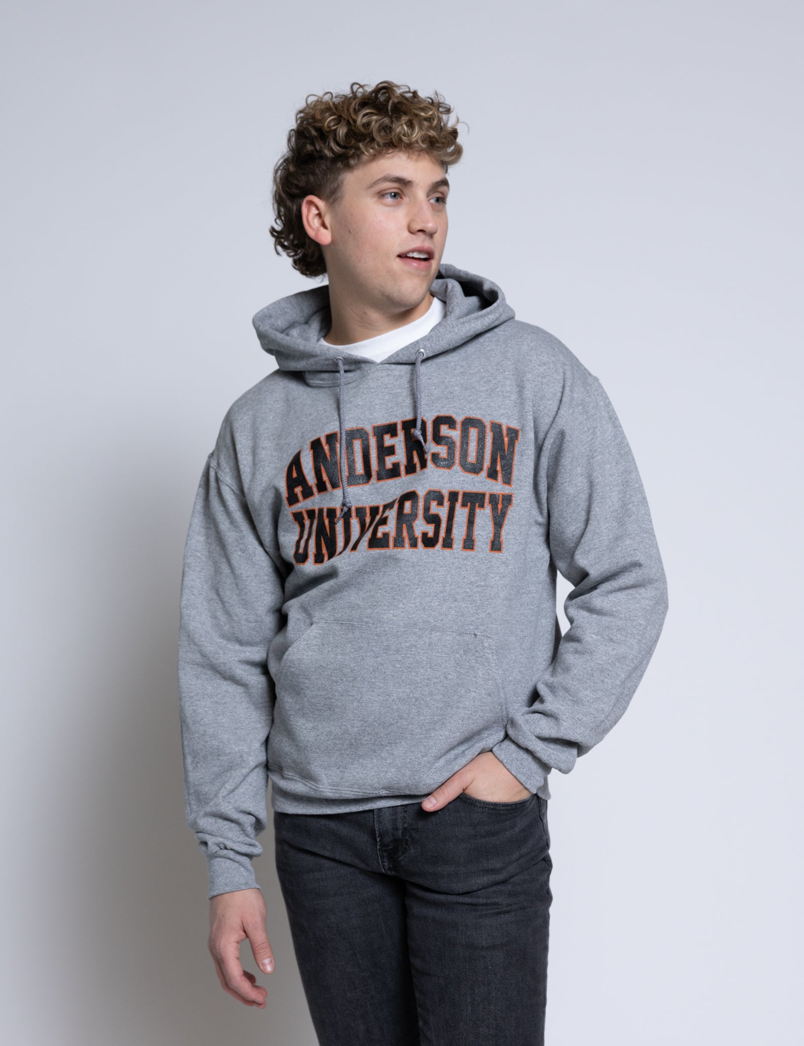 Person wearing a gray hoodie with 'Anderson University' text on a plain background