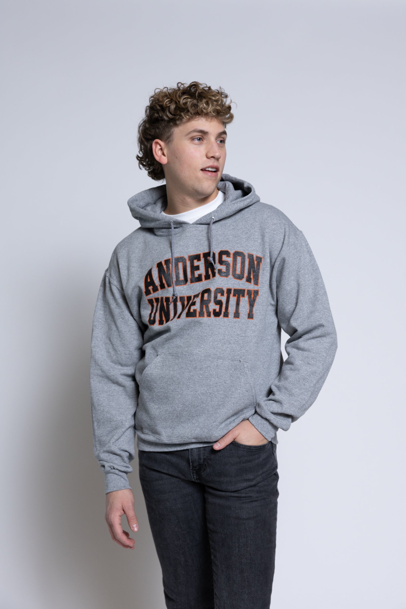 Person wearing a gray hoodie with 'Anderson University' text on a plain background