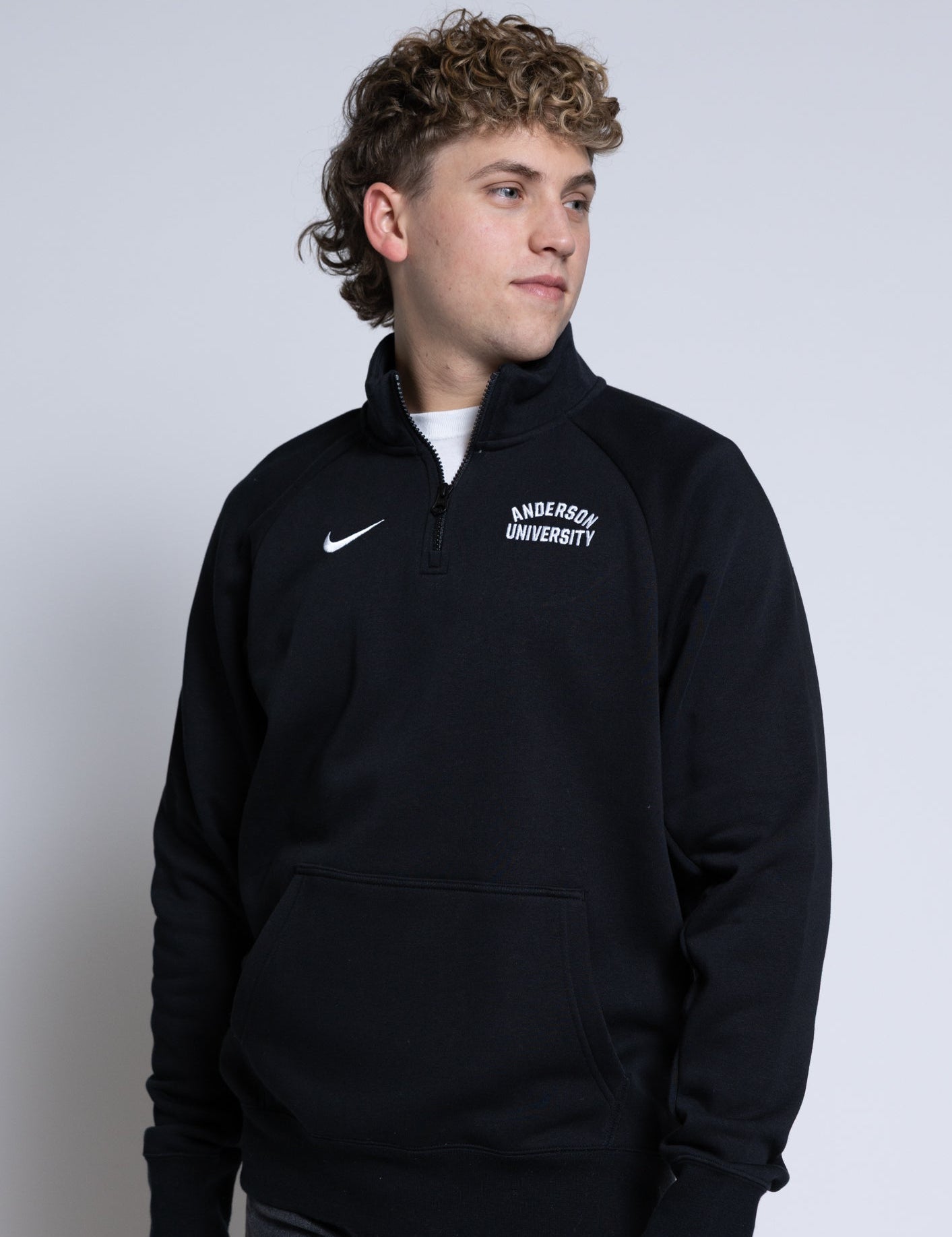Person wearing a black quarter-zip sweatshirt with 'Anderson University' text on a plain background