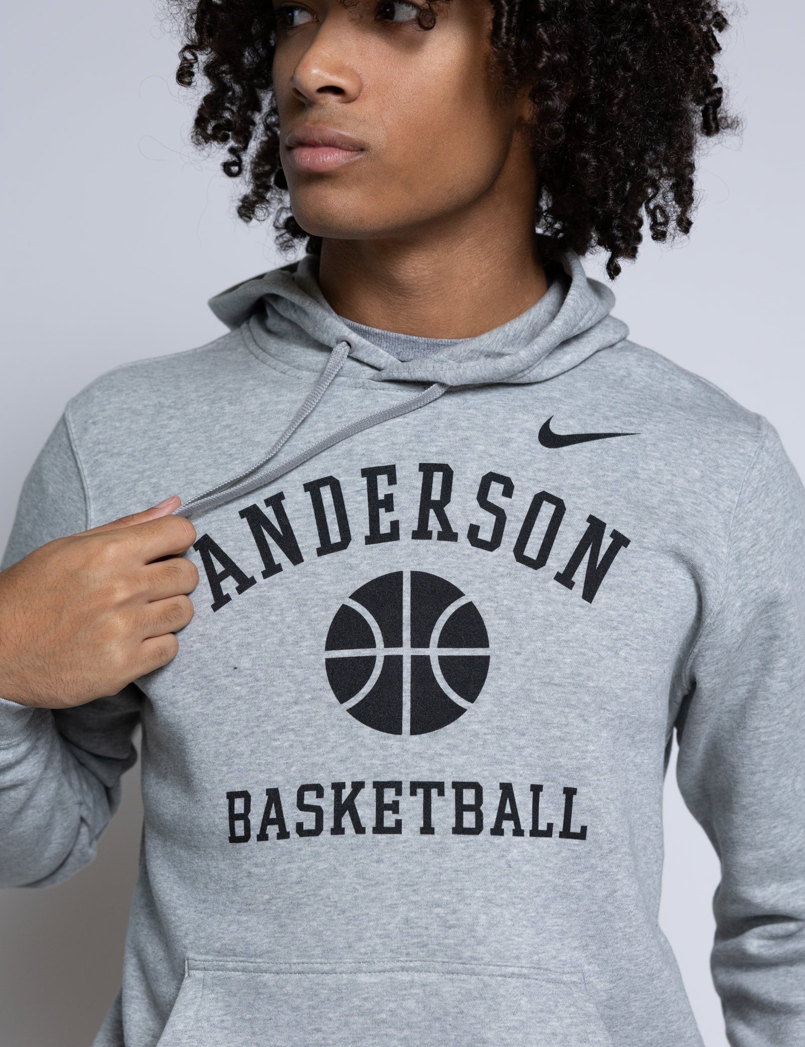 Person wearing a gray hoodie with 'Anderson Basketball' text and Nike logo.