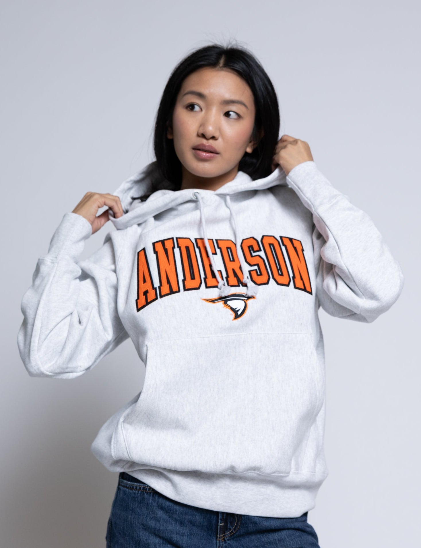 Person wearing a hoodie with 'Anderson' printed on it against a plain background