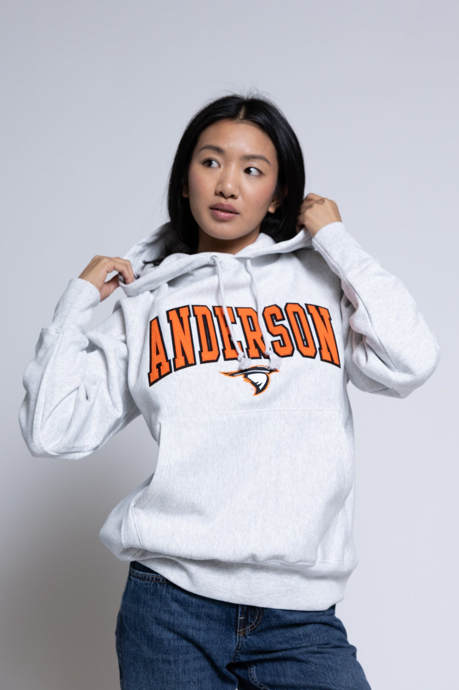 Person wearing a hoodie with 'Anderson' printed on it against a plain background