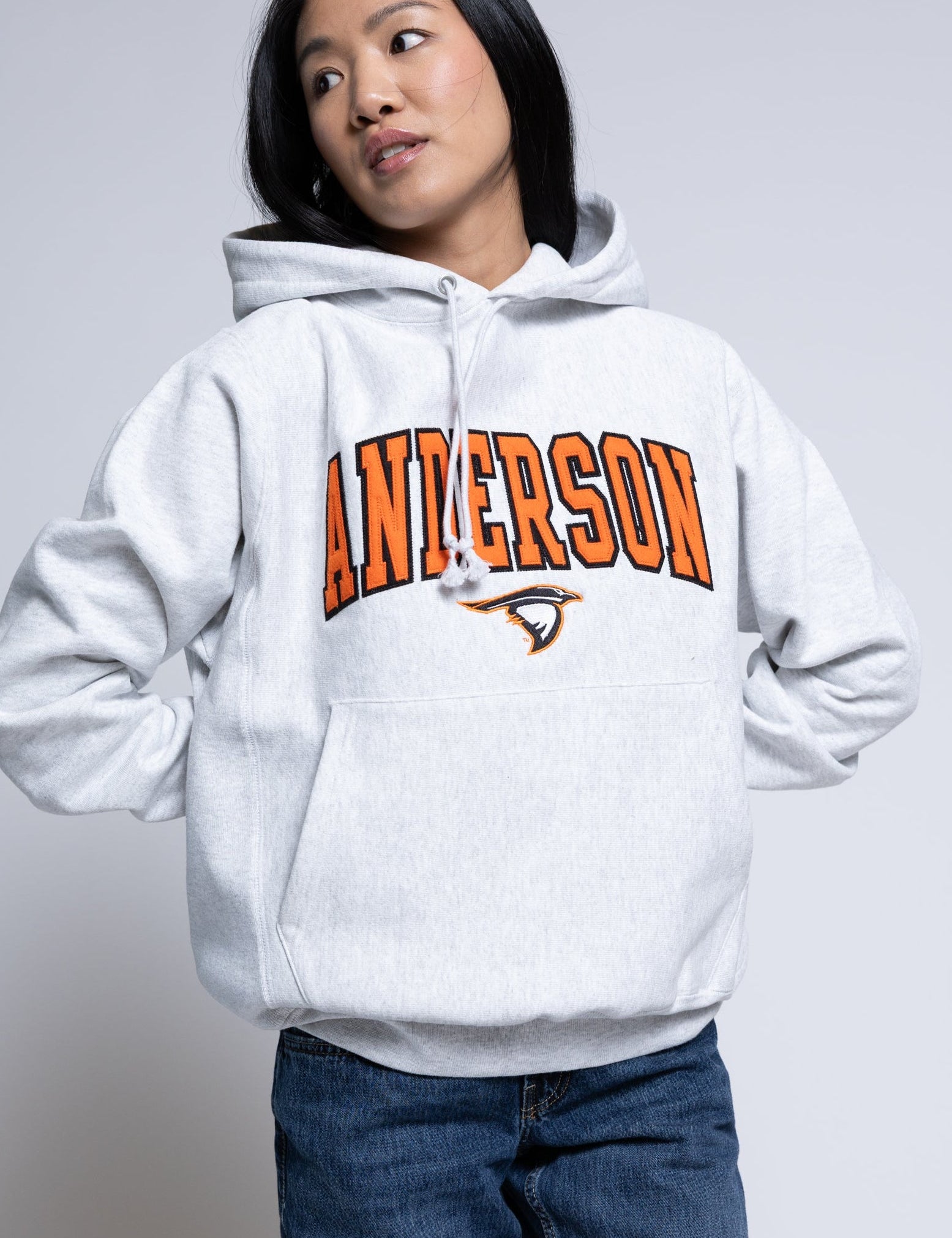 Person wearing a hoodie with 'Anderson' printed on it against a plain background