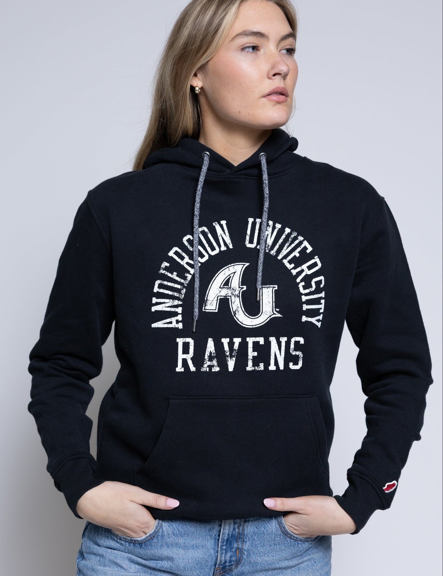Person wearing a black hoodie with 'Anderson University Ravens' text and logo.