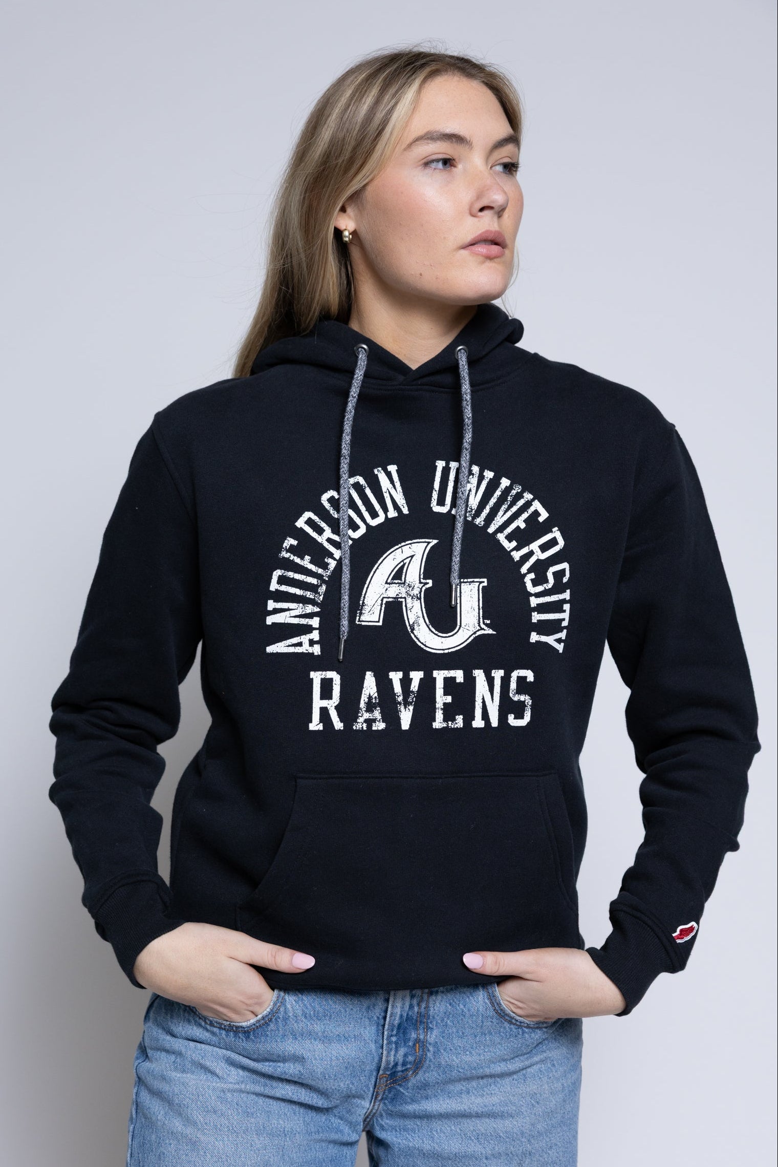 Person wearing a black hoodie with 'Anderson University Ravens' text and logo.